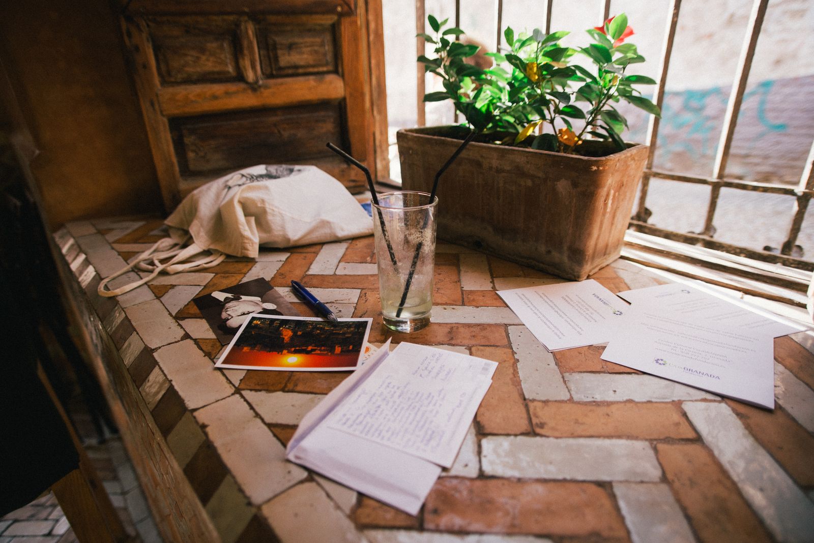 A few opened letters resting on a sunlit windowsill